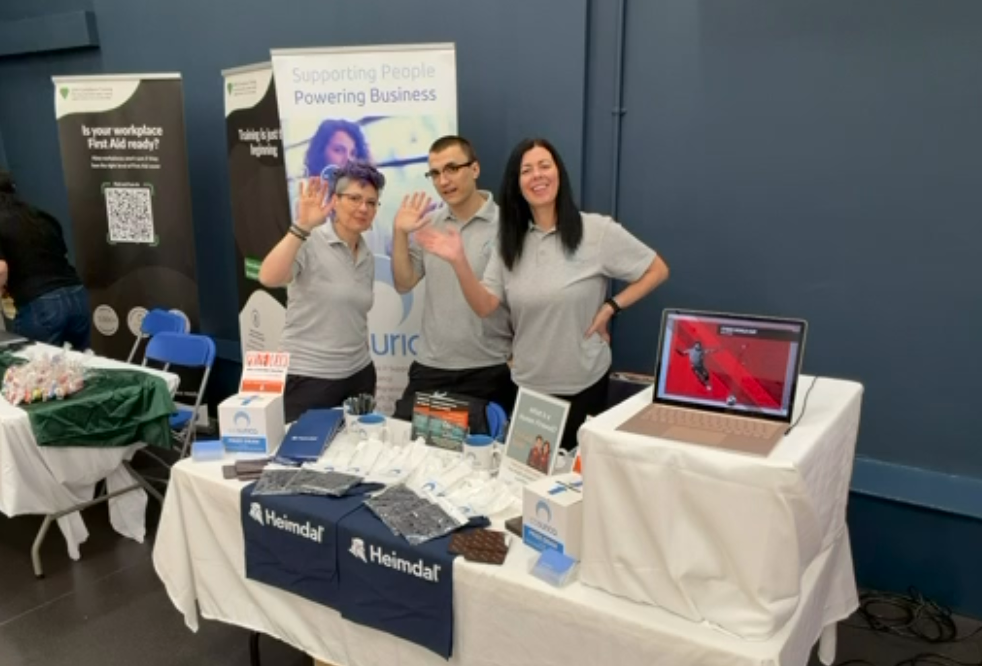 Three business people on an exhibition stand at Airedale Business Showcase